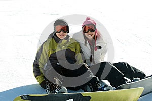 Couple teen snowboarders