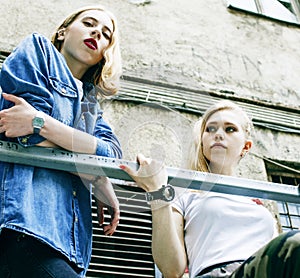 Couple of teenage girls outside on streets chilling, lifestyle people concept