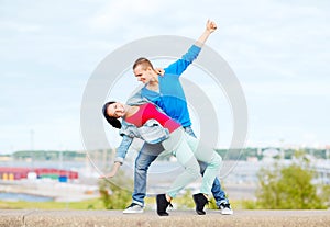 Couple of teenagers dancing outside