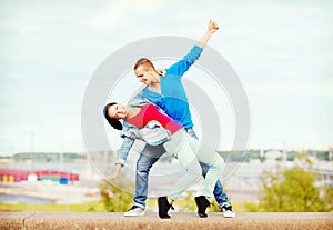 Couple of teenagers dancing outside