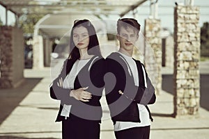 A couple of teenagers on a walk with a boombox.Beautiful girl in a black tracksuit