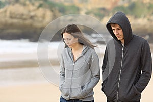Couple of teenagers walking sad photo