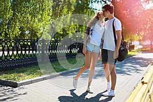 Couple teens in love walking in the park in summer day, youth