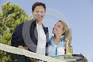 Couple at Tennis Net portrait low angle view