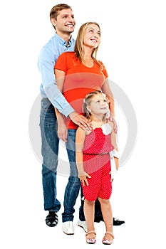 Couple with their girl child looking upwards