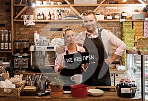 Couple in their new cafe, proud news business owners