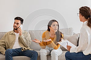 Couple in therapy session with counselor, crisis in relationships