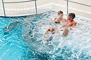 Couple in thermal wellness spa on water massage photo