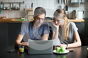 Couple thinking of family budget planning with laptop and papers