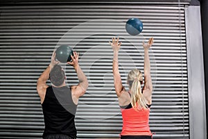 Couple throwing ball in the air