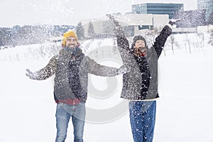 Couple throwing snow and enjoying winter