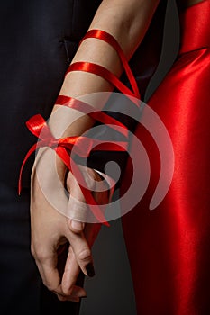 Couple Tied Hands, Woman and Man Arms Bonded Together by Red Ribbon, Relationship