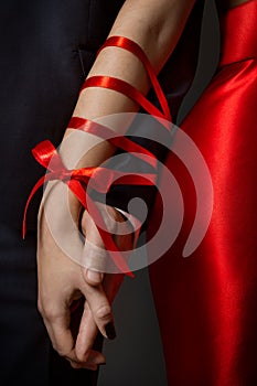 Couple Tied Hands, Woman and Man Arms Bonded Together by Red Ribbon, Relationship photo