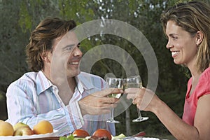 Couple Toasting Ay Garden Table