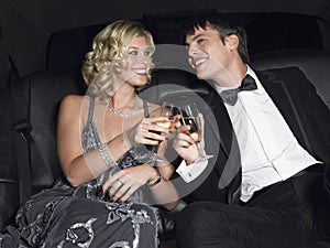 Couple Toasting Champagne In Limousine photo