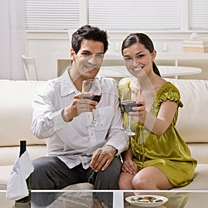 Couple toasting red wine celebrating anniversary