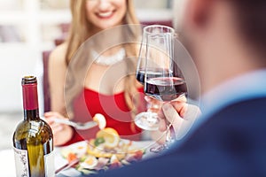 Couple toasting with red wine in romantic restaurant