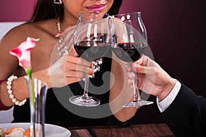 Couple toasting wineglasses in restaurant