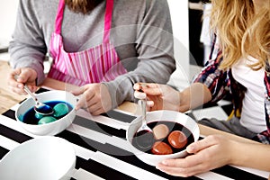 Couple together decorate eggs