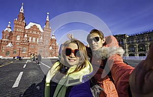 Couple of tourist in love takes selfie portrait on vacation in State Historical Museum on Red Square in Moscow