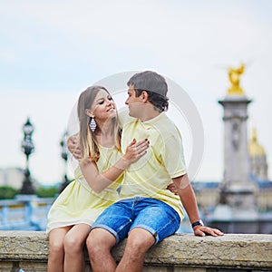 Couple of tourist in Paris, on the famous Alexandre III bridge over the Seine