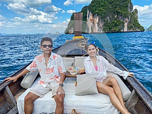 Couple  tourist in private longtail boat trip to island with exotic food picnic, Krabi, Thailand. landmark, destination, Asia