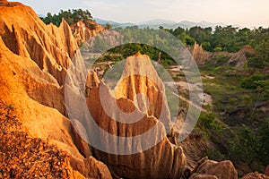 Couple tourists at ancient scenic landscape at sunset. The Sao Din Na Noi site displays picturesque scenery of eroded sandstone