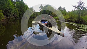 Couple of tourists boating on river, wild nature, active rest