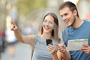 Couple of tourists checking location on the street