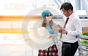 Couple of tourists consulting a city guide searching locations