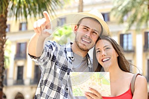 Couple of tourists consulting a guide map