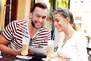 Couple of tourists drinking frappe in a cafe photo