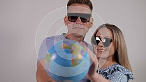Couple of tourists with a globe and passports with tickets on a white background