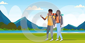 Couple tourists hikers using compass searching direction hiking concept man woman african american travelers on hike