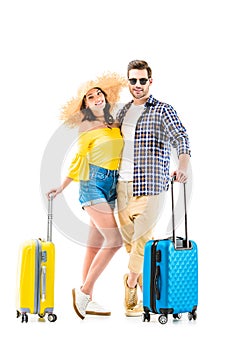 Couple of tourists holding luggages