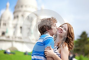 Couple of tourists kissing by Sacre-Coeur
