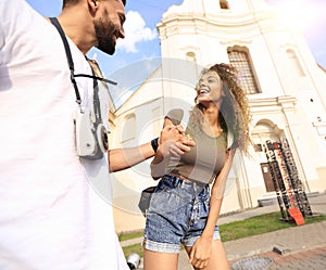 Couple of tourists look at each other and walking