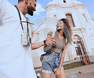 Couple of tourists look at each other and walking