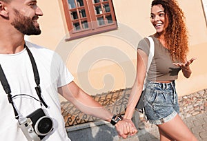 Couple of tourists look at each other and walking