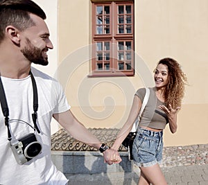 Couple of tourists look at each other and walking