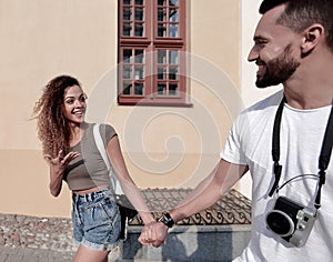 Couple of tourists look at each other and walking