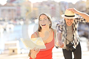 Couple of tourists running in travel destination photo