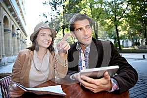 Couple of tourists sitting in coffee shop