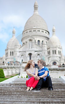 Couple of tourists sitting by Sacre-Coeur