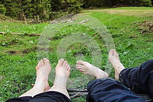 A couple of tourists slept and relaxed lying on the grass