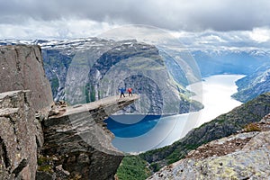 Couple of tourists on Trolltunga in Norway