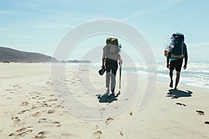 Couple tourists walking on the beach