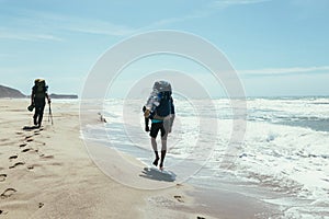 Couple tourists walking on the beach