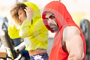 Couple Training on Bicycle in a Gym