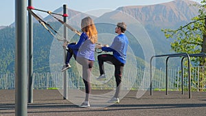 Couple training together using trx straps